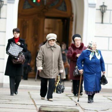 Women walk past a church in the old town of moscow